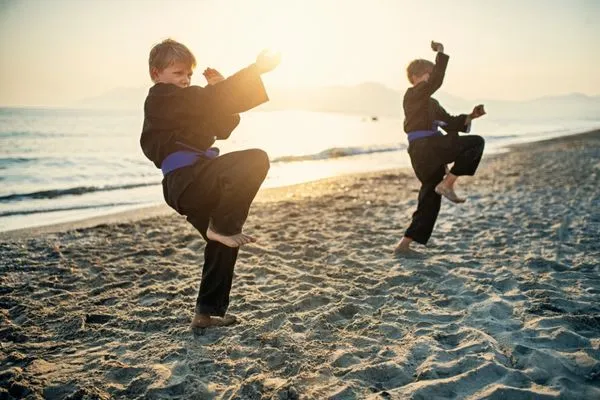 teen kicking in martial arts class